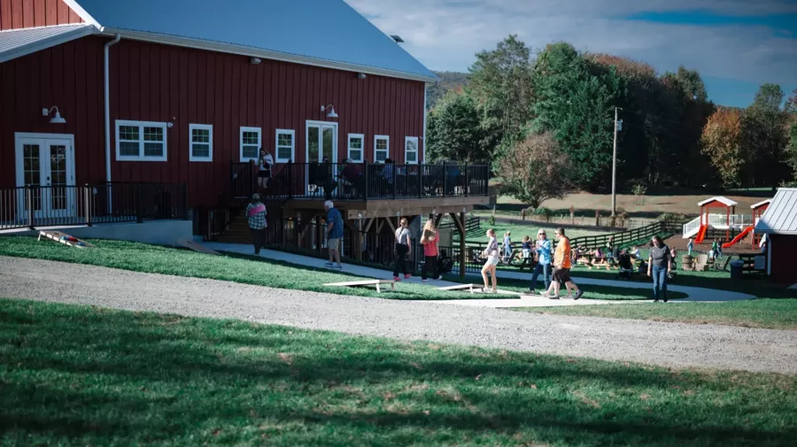 The red barn and lawn games on the property